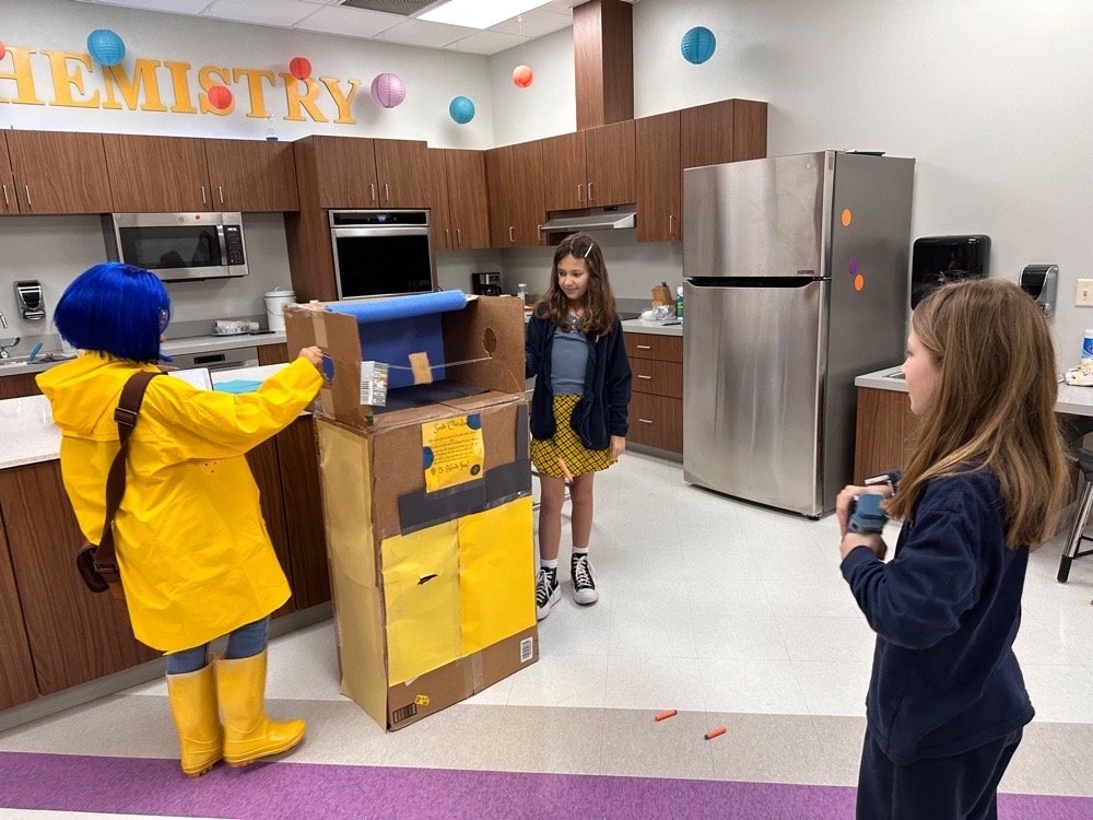 Students at cardboard arcade